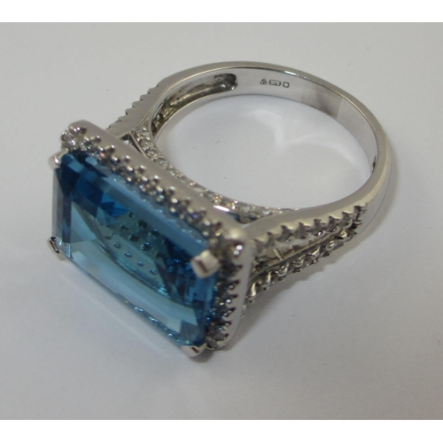 75 - A blue topaz and diamond dress ring