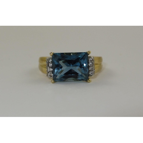 77 - A blue topaz and diamond dress ring