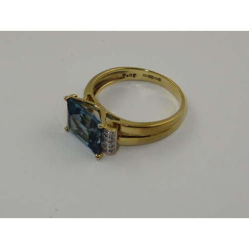 77 - A blue topaz and diamond dress ring