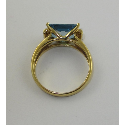 77 - A blue topaz and diamond dress ring