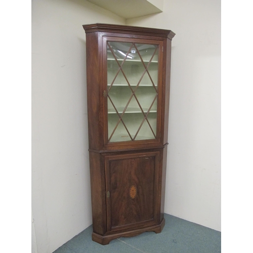 819 - An antique mahogany inlaid corner cabinet