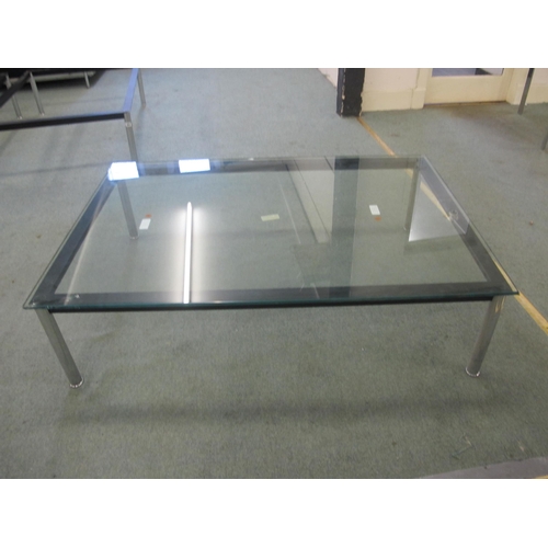 843 - A modern glass top coffee table on chrome supports