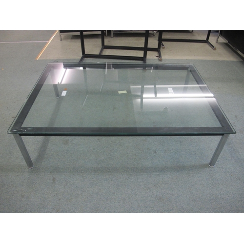 844 - A modern glass top coffee table on chrome supports