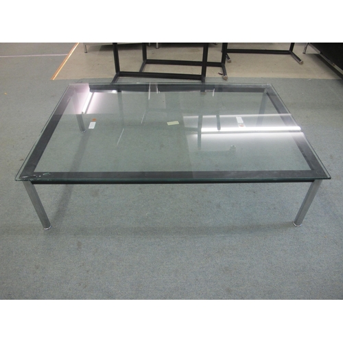 845 - A modern glass top coffee table on chrome supports