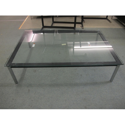 846 - A modern glass top coffee table on chrome supports