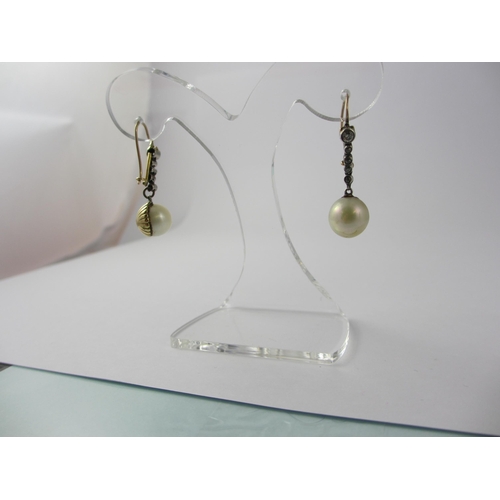 35 - A pair of pearl and diamond earrings.