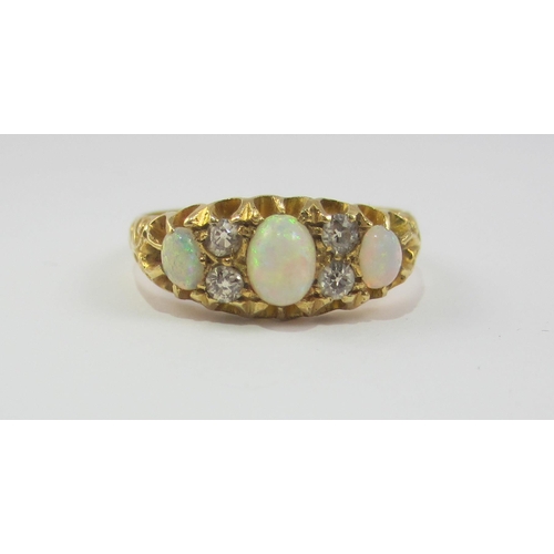 65 - An 18ct opal and diamond ring.