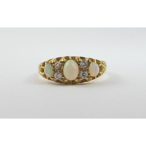 65 - An 18ct opal and diamond ring.