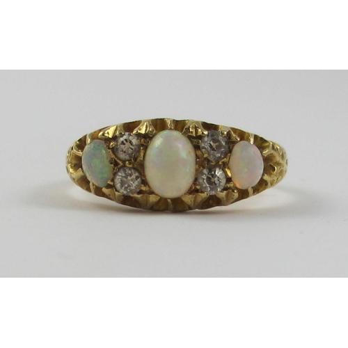 65 - An 18ct opal and diamond ring.