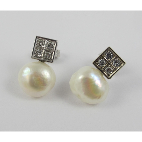 77 - A pair of diamond and pearl stud earrings