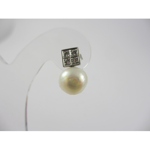 77 - A pair of diamond and pearl stud earrings