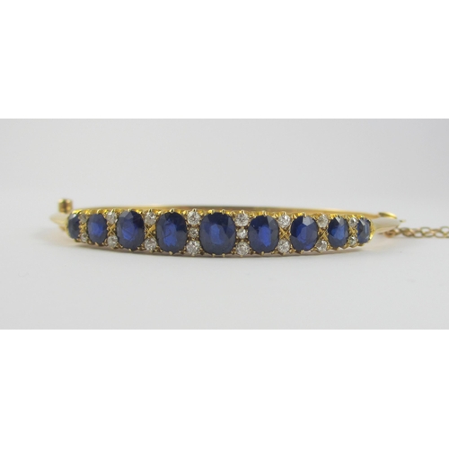 86 - An Edwardian sapphire and diamond bangle