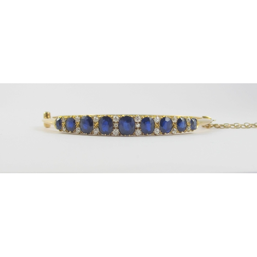 86 - An Edwardian sapphire and diamond bangle