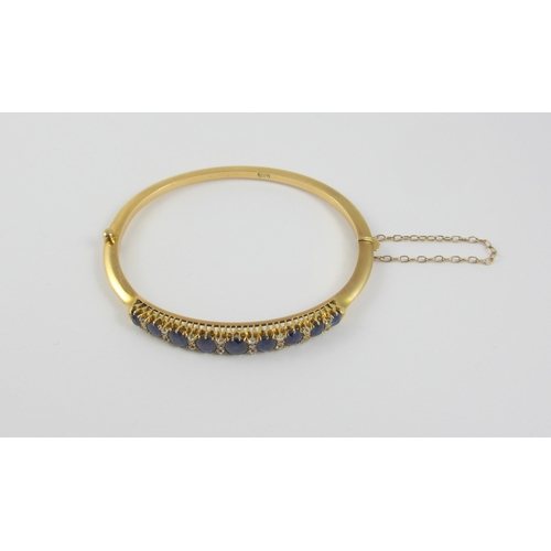 86 - An Edwardian sapphire and diamond bangle