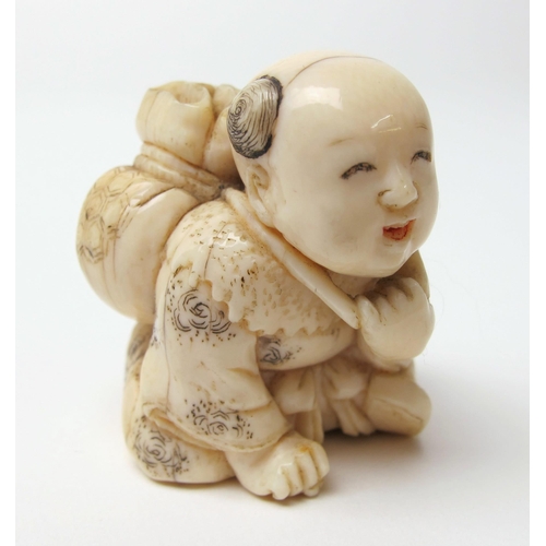 525 - A Japanese ivory netsuke of a young boy