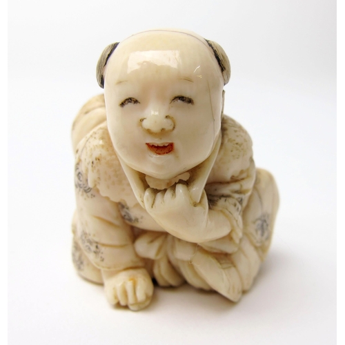 525 - A Japanese ivory netsuke of a young boy