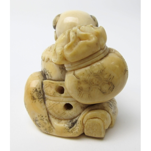 525 - A Japanese ivory netsuke of a young boy