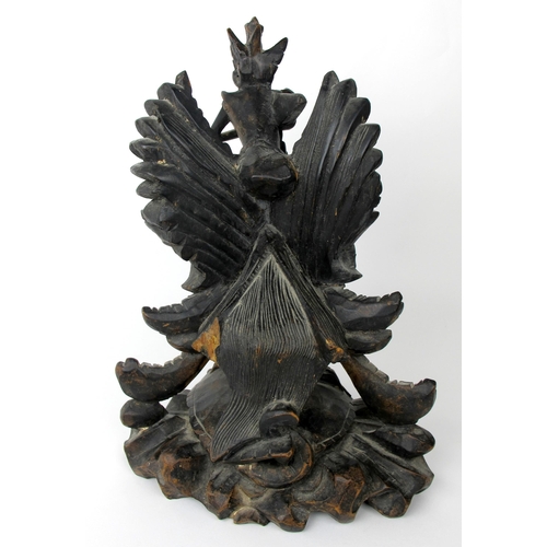 536 - An Indonesian carved and stained wood group of Garuda