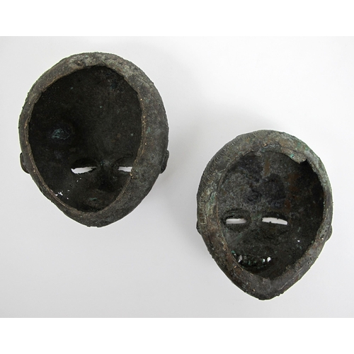 550 - Two African bronze grotesque masks