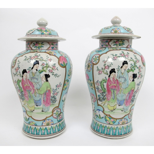 565 - A pair of Cantonese famille rose baluster jars and covers