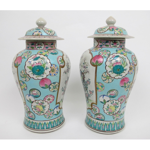 565 - A pair of Cantonese famille rose baluster jars and covers