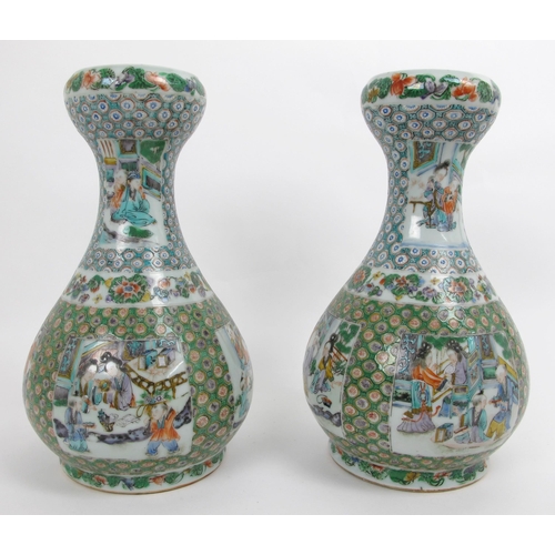 569 - A pair of Cantonese famille rose baluster shaped vases