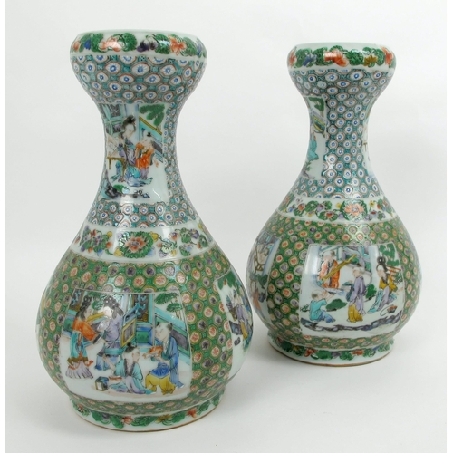 569 - A pair of Cantonese famille rose baluster shaped vases