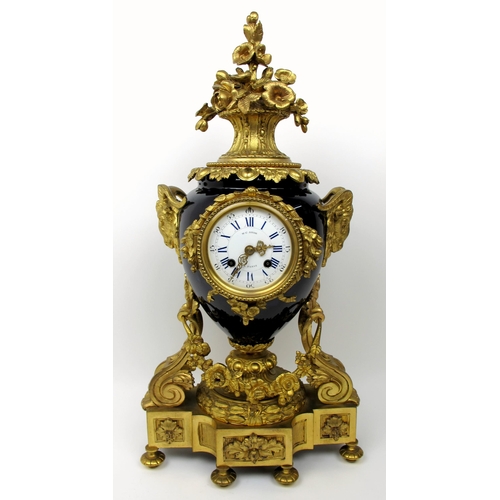 632 - A Louis XVI style gilt metal and porcelain mantle clock