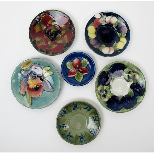 668 - A group of Moorcroft pottery saucers