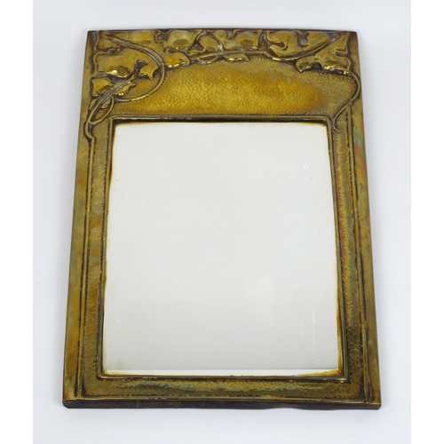 678 - An Arts and Crafts brass mirror