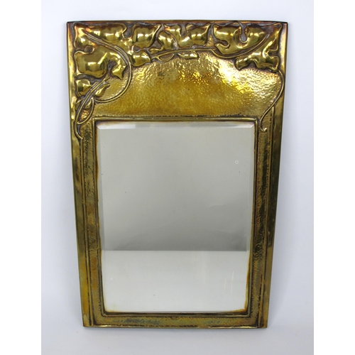 678 - An Arts and Crafts brass mirror