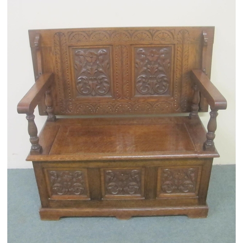 794 - A carved oak Monks bench