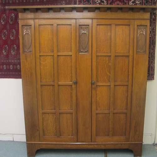 812 - An Arts and Crafts oak wardrobe in the style of Liberty