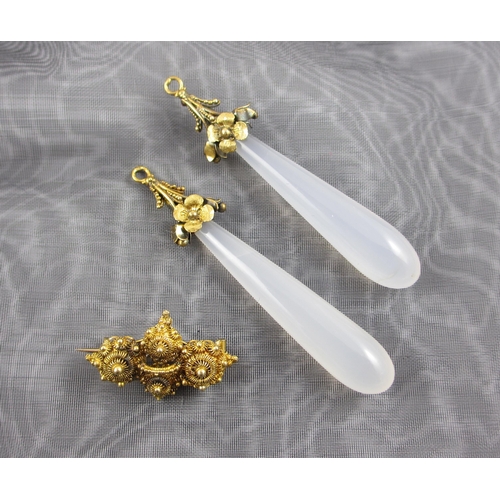 101 - Two white agate pendant drops  with yellow metal floral mounts (probably orginally earrings)  togeth... 