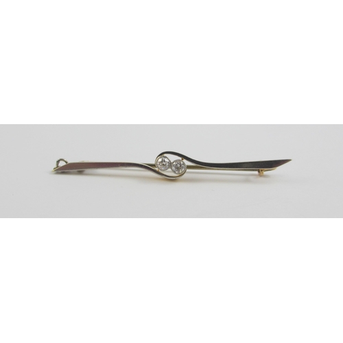 102 - A 18ct yellow and white metal bar brooch set with two diamonds in a twist design. Approx weight 3.1g... 