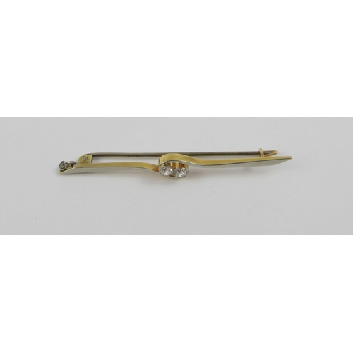 102 - A 18ct yellow and white metal bar brooch set with two diamonds in a twist design. Approx weight 3.1g... 