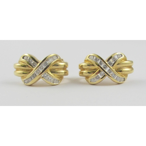 109 - A pair of 14ct yellow gold earrings  with channel set diamonds set into a kiss shape. Post and clip ... 