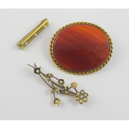 111 - A collection of three brooches  a 9ct gold mounted banded carnelian brooch  together with a seed pea... 