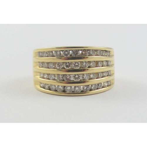 112 - A 10ct yellow gold ring set with forty four channel set brilliant cut diamonds. Ring size N 1/2.