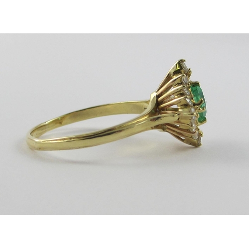 113 - An emerald and diamond ring  a square cut emerald claw set  surrounded with 16 brilliant cut claw se... 