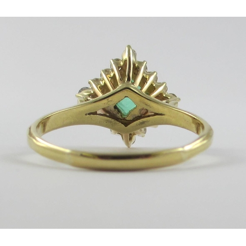 113 - An emerald and diamond ring  a square cut emerald claw set  surrounded with 16 brilliant cut claw se... 