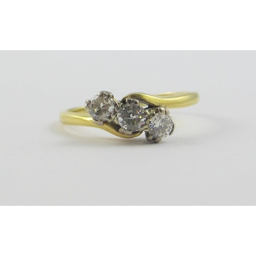 114 - A 18ct three stone diamond ring  approx diamond weight 0.3cts claw set in a twist design  size L.