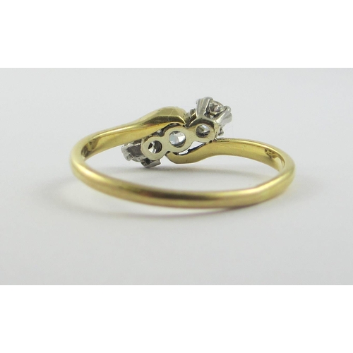 114 - A 18ct three stone diamond ring  approx diamond weight 0.3cts claw set in a twist design  size L.