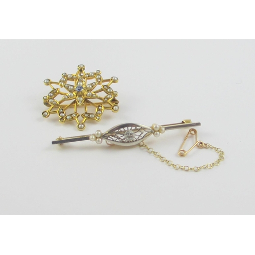 115 - Two Edwardian brooches  A yellow and white metal bar brooch set with a diamond in an intricate pierc... 