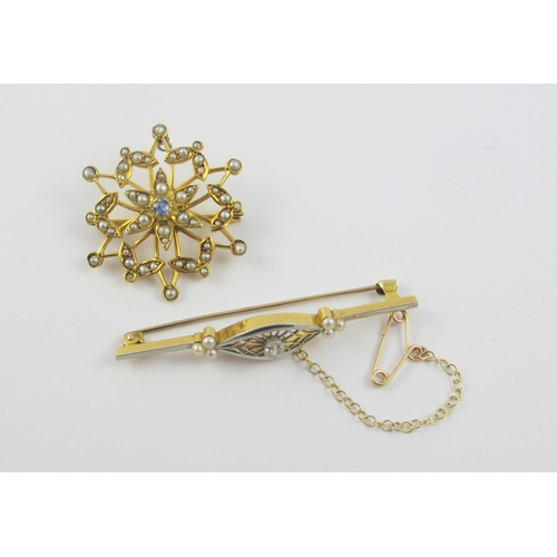 115 - Two Edwardian brooches  A yellow and white metal bar brooch set with a diamond in an intricate pierc... 