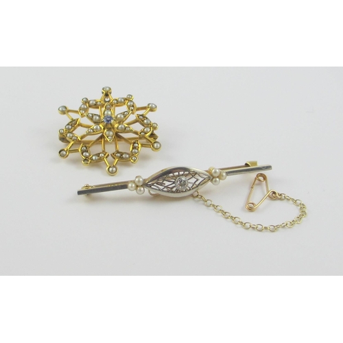 115 - Two Edwardian brooches  A yellow and white metal bar brooch set with a diamond in an intricate pierc... 