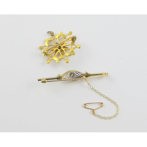 115 - Two Edwardian brooches  A yellow and white metal bar brooch set with a diamond in an intricate pierc... 