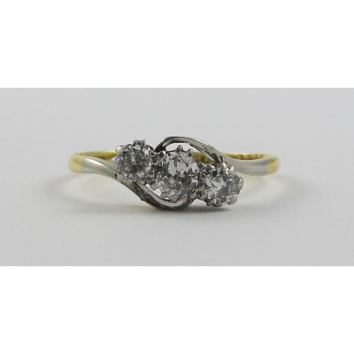 120 - An 18ct and platinum three stone diamond ring  the diamonds claw set in a twist design   approx diam... 