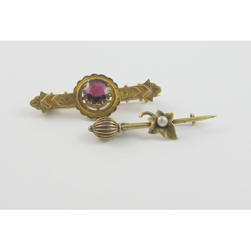 121 - A 9ct Victorian brooch in the classical revival style set with a garnet  together with a yellow meta... 