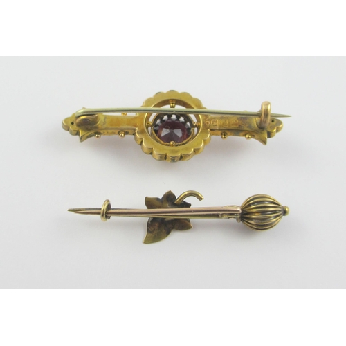 121 - A 9ct Victorian brooch in the classical revival style set with a garnet  together with a yellow meta... 